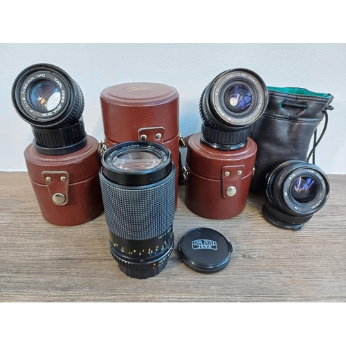 83 - Four cased Carl Zeiss camera lenses, one Jena DDR P 1:1.8 f=50mm MC, one Jenazoom 1:4.5-5.6 70-210mm... 