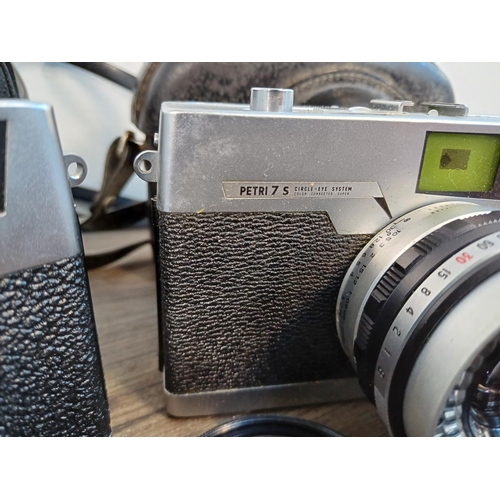 89 - Two cased Petri 35mm rangefinder cameras fitted with 2.8/45mm lenses, one 1960s 7S and one 1970s 7S ... 