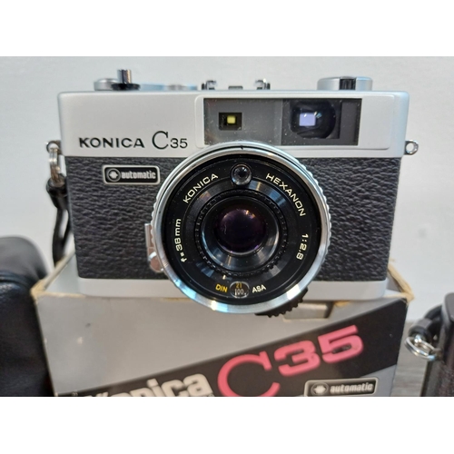 90 - Two Konishiroku Konica C35 compact 35mm rangefinder cameras fitted with Hexanon 1:2.8 f=38mm lenses ... 