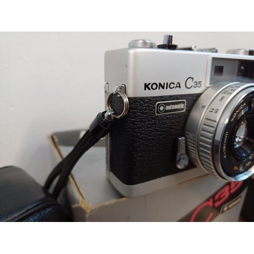 90 - Two Konishiroku Konica C35 compact 35mm rangefinder cameras fitted with Hexanon 1:2.8 f=38mm lenses ... 