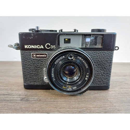 90 - Two Konishiroku Konica C35 compact 35mm rangefinder cameras fitted with Hexanon 1:2.8 f=38mm lenses ... 