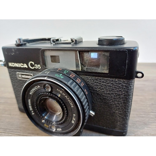 90 - Two Konishiroku Konica C35 compact 35mm rangefinder cameras fitted with Hexanon 1:2.8 f=38mm lenses ... 