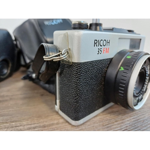 91 - Two cased Ricoh 35mm cameras fitted with Rikenon 1:2.8 f=40mm lenses, one 500 G compact coupled rang... 