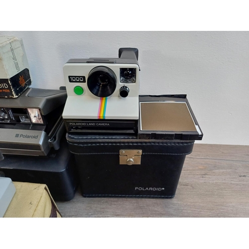 242 - A collection of Polaroid items to include Snap instant print digital camera, 1990s Vision and Vision... 