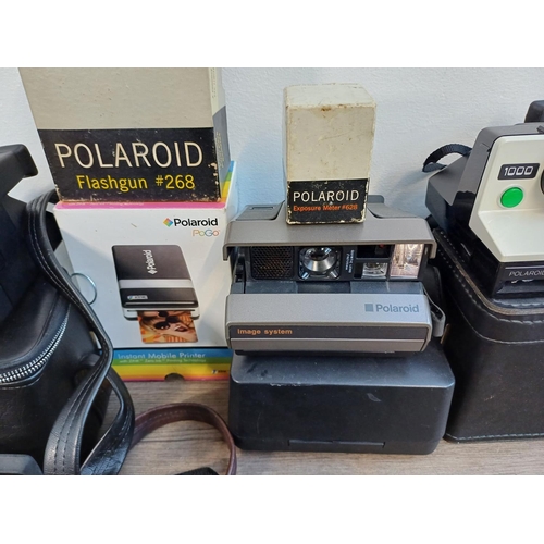 242 - A collection of Polaroid items to include Snap instant print digital camera, 1990s Vision and Vision... 