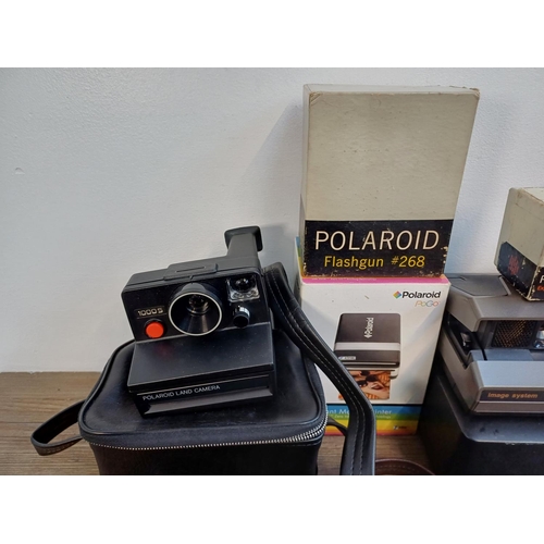 242 - A collection of Polaroid items to include Snap instant print digital camera, 1990s Vision and Vision... 