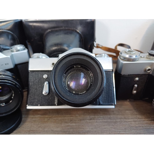 245 - Five KMZ Zenit B 35mm SLR cameras, two cased fitted with Helios-44-2 2.8/58 lenses, one fitted with ... 