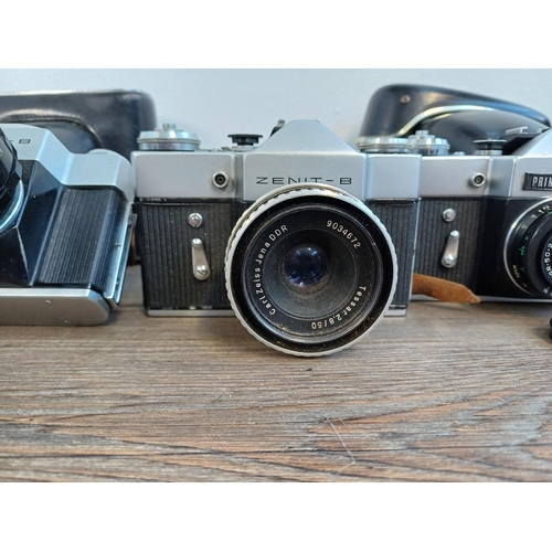 245 - Five KMZ Zenit B 35mm SLR cameras, two cased fitted with Helios-44-2 2.8/58 lenses, one fitted with ... 