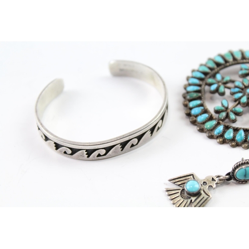 2074 - Four pieces of Native American sterling silver jewellery to include turquoise brooch etc. - approx. ... 