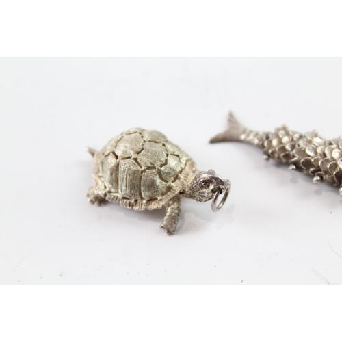 2081 - Two sterling silver animal pendants to include articulated fish - approx. gross weight 22g