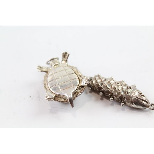 2081 - Two sterling silver animal pendants to include articulated fish - approx. gross weight 22g