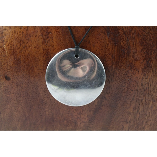 2087 - An Else Peretti Tiffany & Co sterling silver round pendant on cord - approx. gross weight 28g