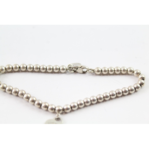 2093 - A Tiffany & Co Sterling silver beaded bracelet with heart charm - approx. gross weight 6g