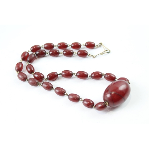 2110 - A cherry Bakelite beaded necklace with internal streaking - approx. gross weight 23.6g