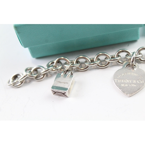 2117 - A boxed Tiffany & Co sterling silver charm bracelet with replacement clasp - approx. gross weight 45... 