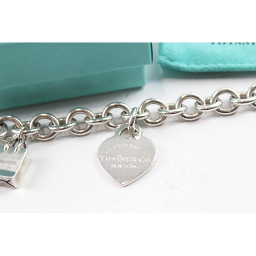 2117 - A boxed Tiffany & Co sterling silver charm bracelet with replacement clasp - approx. gross weight 45... 