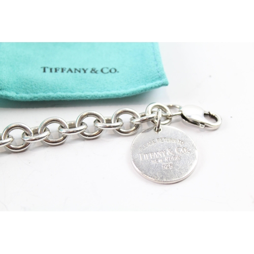 2117 - A boxed Tiffany & Co sterling silver charm bracelet with replacement clasp - approx. gross weight 45... 