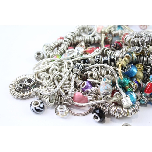 2119 - A collection of bracelets and loose charms to include beaded, enamel etc.