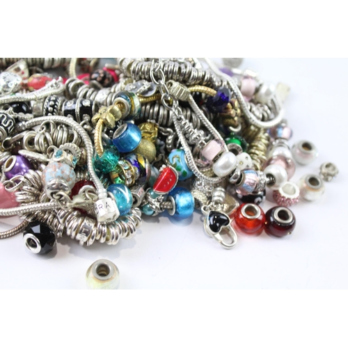 2119 - A collection of bracelets and loose charms to include beaded, enamel etc.