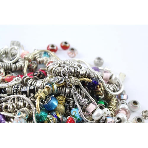 2119 - A collection of bracelets and loose charms to include beaded, enamel etc.