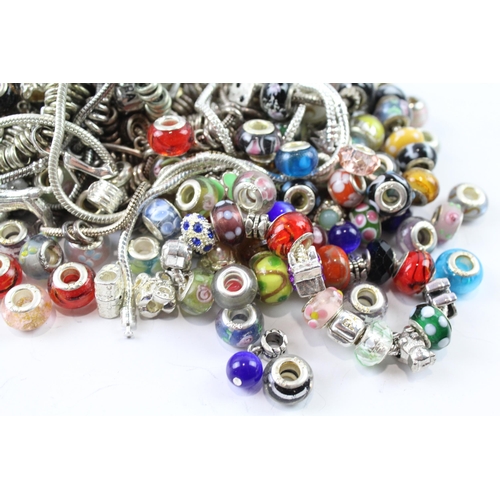 2120 - A collection of bracelets and loose charms to include beaded, glass etc.