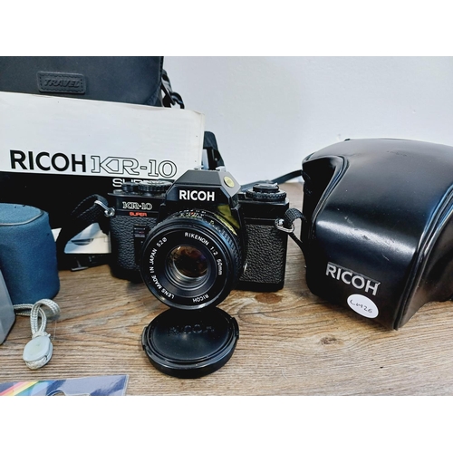 253 - A collection of cameras and photography accessories to include cased Ricoh KR-10 Super 35mm SLR came... 