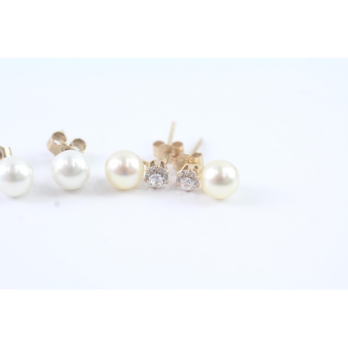 2025 - Two pairs of 9ct gold faux pearl and CZ stud earrings - approx. gross weight 1g