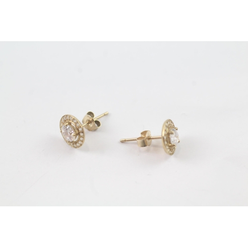 2037 - A pair of 9ct gold CZ halo stud earrings - approx. gross weight 0.8g