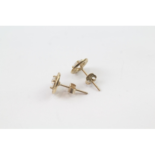 2037 - A pair of 9ct gold CZ halo stud earrings - approx. gross weight 0.8g