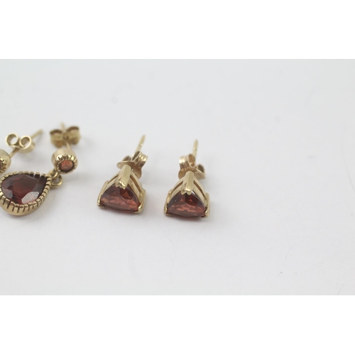 2041 - Two pairs of 9ct gold garnet drop and stud earrings - approx. gross weight 3.1g