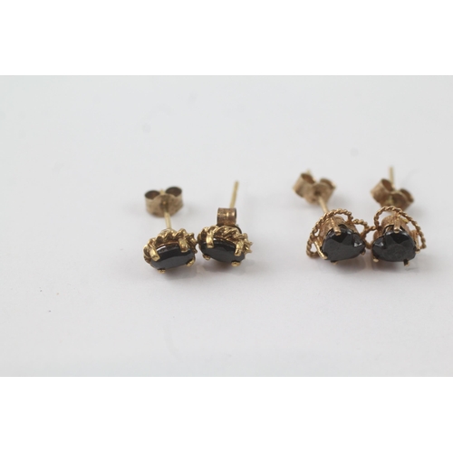 2043 - Two pairs of 9ct gold sapphire stud earrings - approx. gross weight 1.6g