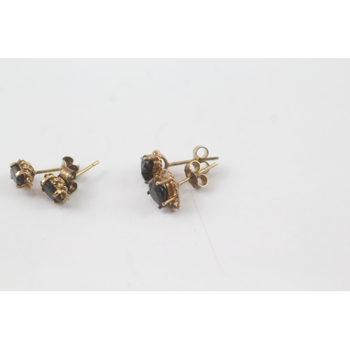 2043 - Two pairs of 9ct gold sapphire stud earrings - approx. gross weight 1.6g