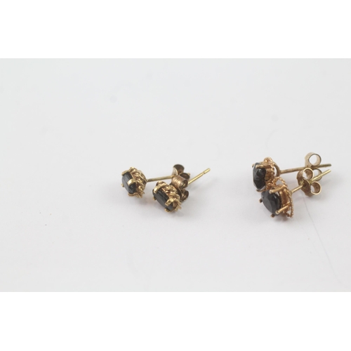 2043 - Two pairs of 9ct gold sapphire stud earrings - approx. gross weight 1.6g