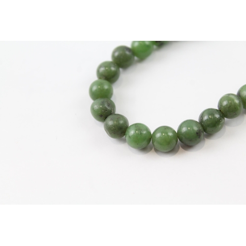 2055 - A nephrite beaded necklace with 9ct gold clasp - approx. gross weight 40.3g