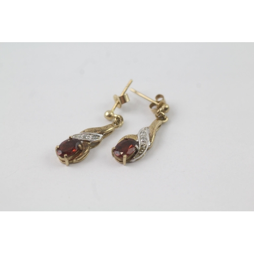 2056 - A pair of 9ct gold garnet and diamond drop dress earrings - approx. gross weight 1.8g