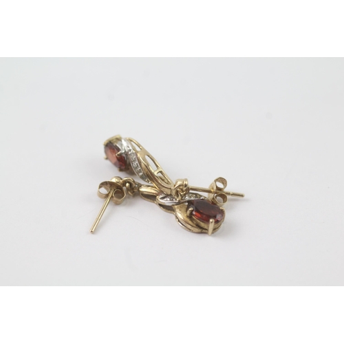 2056 - A pair of 9ct gold garnet and diamond drop dress earrings - approx. gross weight 1.8g