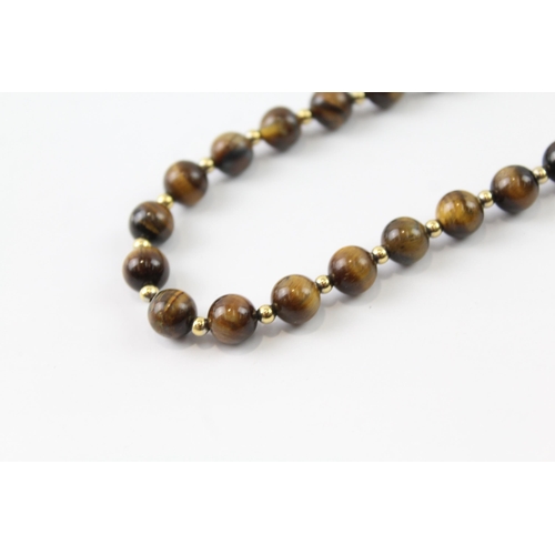 2063 - A tiger's eye beaded necklace with 9ct gold clasp and spacers - approx. gross weight 35g