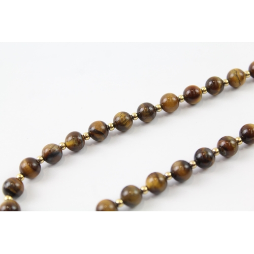 2063 - A tiger's eye beaded necklace with 9ct gold clasp and spacers - approx. gross weight 35g