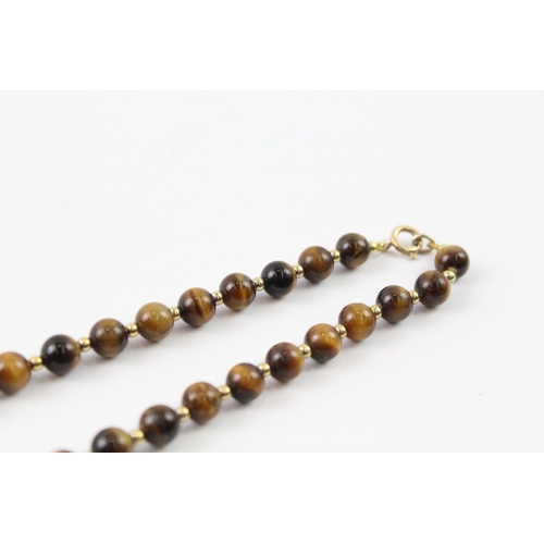 2063 - A tiger's eye beaded necklace with 9ct gold clasp and spacers - approx. gross weight 35g