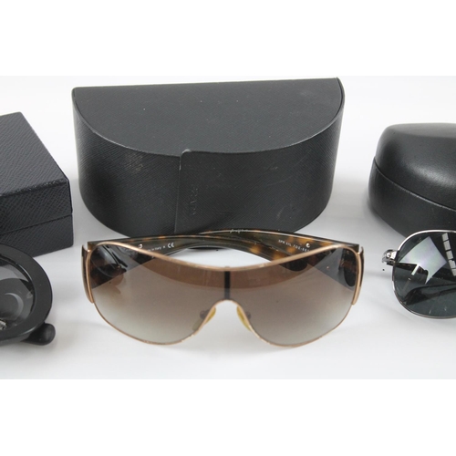 1358 - Three pairs of cased sunglasses to include Prada etc.