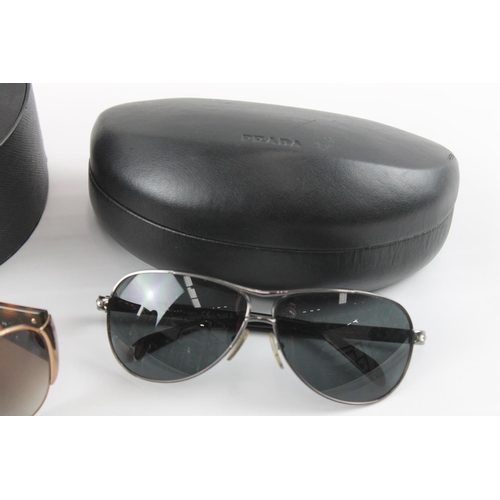 1358 - Three pairs of cased sunglasses to include Prada etc.