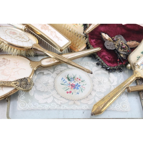 1422 - A collection of vanity and grooming items to include brushes, mirror, beaded purse, perfume etc.