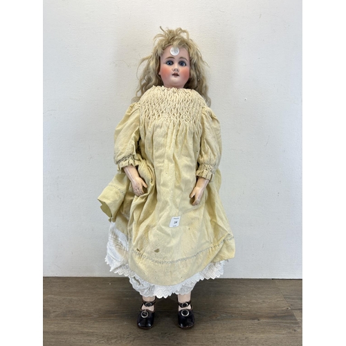 1348 - An antique composite body articulated doll with porcelain head - approx. 65cm high