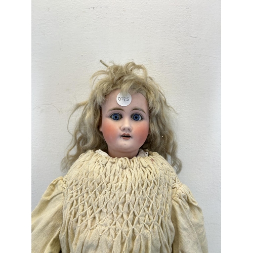 1348 - An antique composite body articulated doll with porcelain head - approx. 65cm high