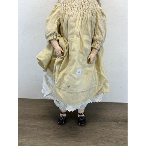 1348 - An antique composite body articulated doll with porcelain head - approx. 65cm high