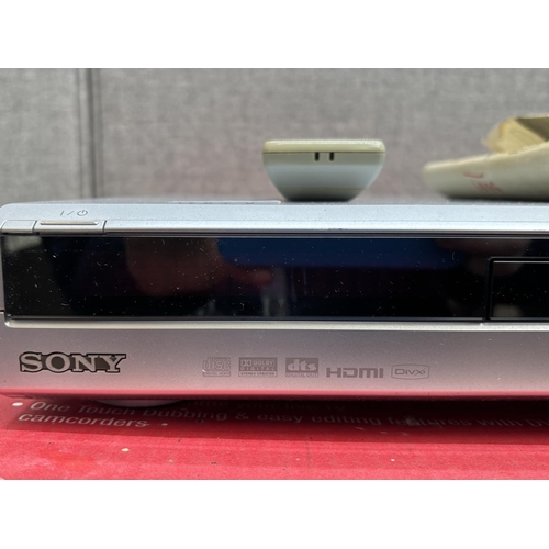 1523A - A boxed Sony RDR-HXD860 hard disc drive and DVD recorder with remote control and instruction manual