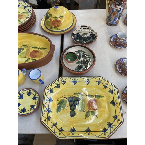 1296 - Sixty one pieces of Portuguese hand painted glazed terracotta pottery