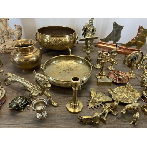 1311 - A collection of metalware to include cast iron doorstop, brass and copper shoe doorstop, brass oval ... 