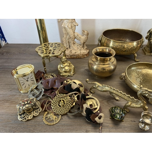 1311 - A collection of metalware to include cast iron doorstop, brass and copper shoe doorstop, brass oval ... 