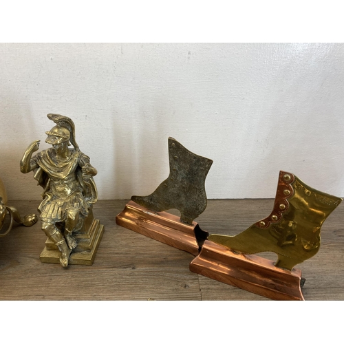 1311 - A collection of metalware to include cast iron doorstop, brass and copper shoe doorstop, brass oval ... 